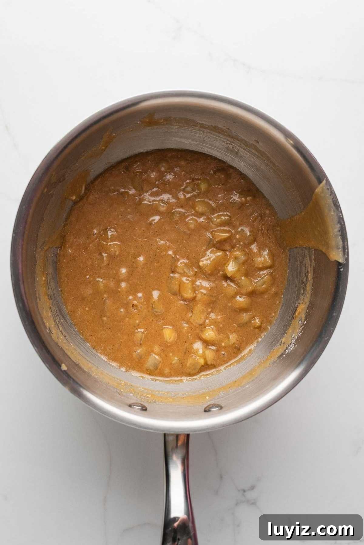 Caramel apple glaze in a saucepan.