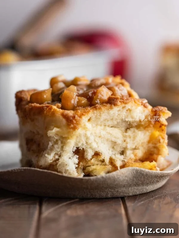 Apple streusel cinnamon roll on a plate.