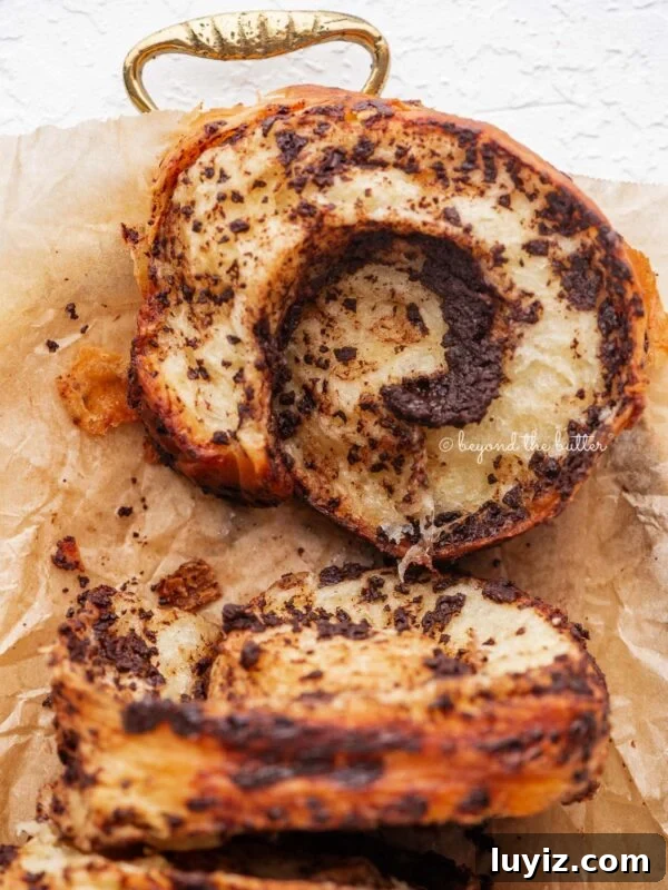 Sliced chocolate croissant loaf on a tray.