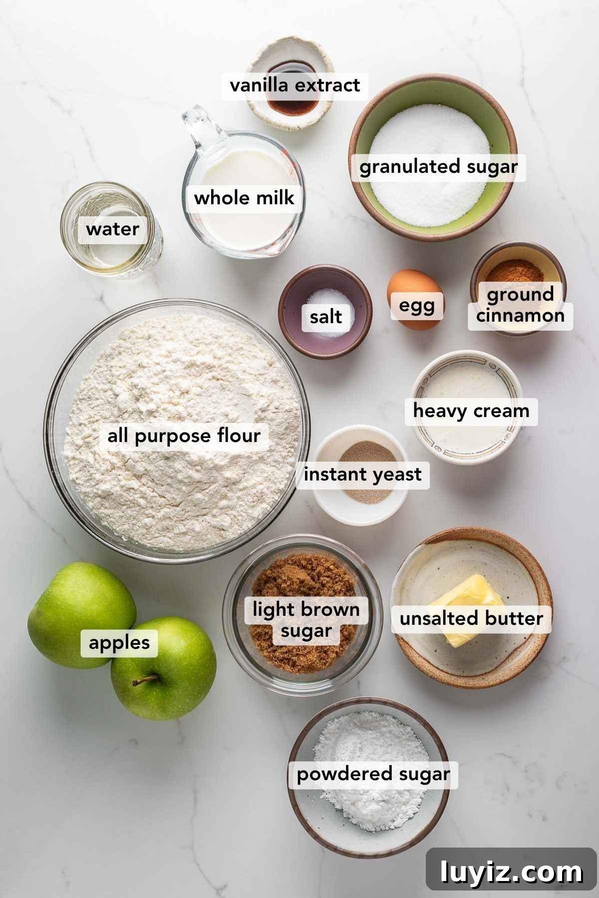 Ingredients for apple streusel cinnamon rolls in bowls on a counter.